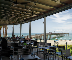 two older couples drinking beer by the water